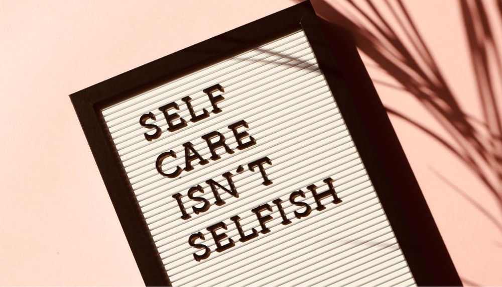 A framed sign that says self care isn 't selfish